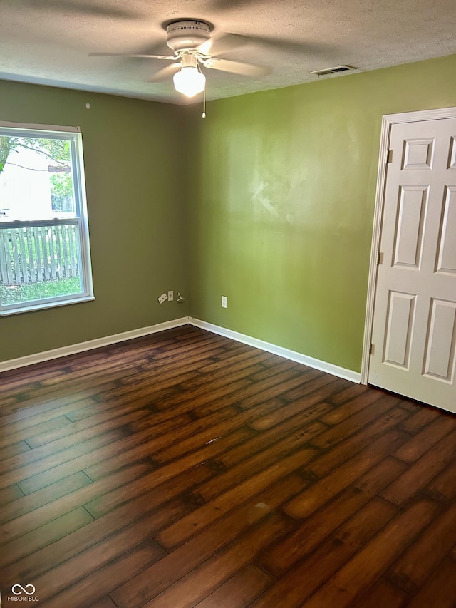 12307 Chiseled Stone Dr, Fishers, IN 46037 - spare room featuring a ceiling fan, dark wood finished floors, a textured ceiling, and baseboards