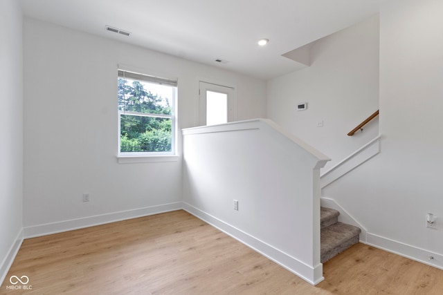 751 Switchyard Pl, Indianapolis, IN 46202 - unfurnished room with light wood-type flooring, baseboards, and stairway