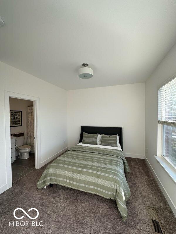 751 Switchyard Pl, Indianapolis, IN 46202 - bedroom featuring carpet flooring, baseboards, and ensuite bath