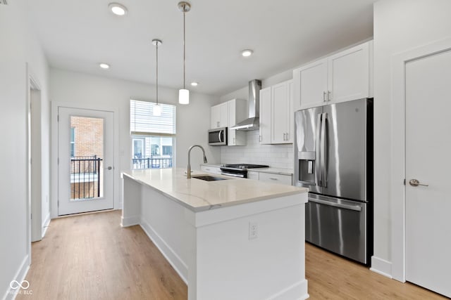 751 Switchyard Pl, Indianapolis, IN 46202 - kitchen with stainless steel appliances, wall chimney exhaust hood, a sink, light wood-type flooring, and white cabinetry