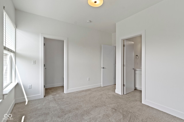 751 Switchyard Pl, Indianapolis, IN 46202 - unfurnished bedroom with carpet floors, baseboards, a walk in closet, and connected bathroom