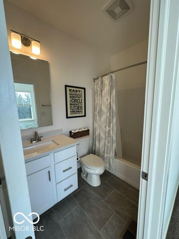 751 Switchyard Pl, Indianapolis, IN 46202 - full bath featuring toilet, vanity, shower / tub combo with curtain, and tile patterned flooring