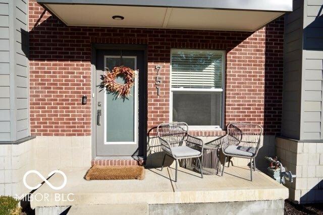 751 Switchyard Pl, Indianapolis, IN 46202 - doorway to property with brick siding and a porch