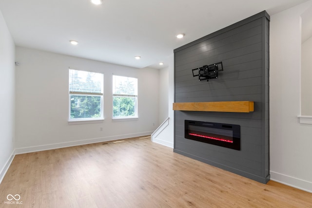 751 Switchyard Pl, Indianapolis, IN 46202 - unfurnished living room featuring wood finished floors, a large fireplace, baseboards, and recessed lighting