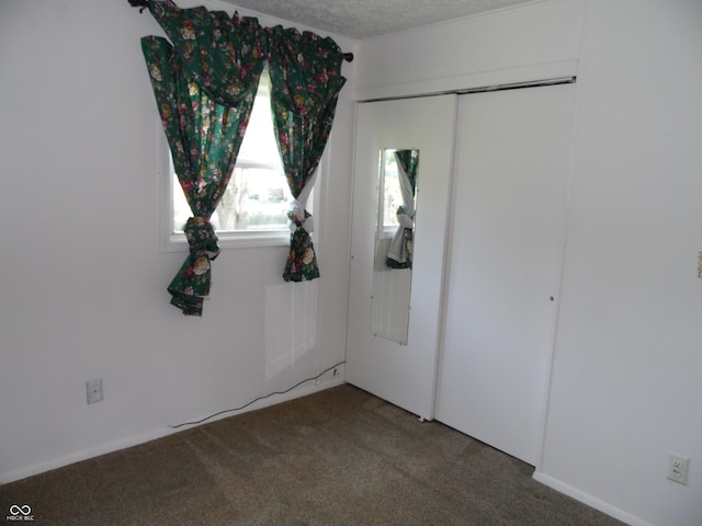 509 Eberhart Dr, Shelbyville, IN 46176 - unfurnished bedroom featuring carpet flooring, a closet, and a textured ceiling