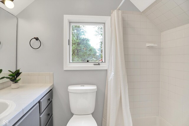 6644 Mcfarland Rd, Indianapolis, IN 46227 - bathroom with vaulted ceiling, vanity, and shower / bath combo