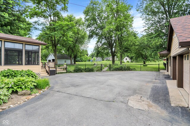 6644 Mcfarland Rd, Indianapolis, IN 46227 - view of patio / terrace with a sunroom and asphalt driveway