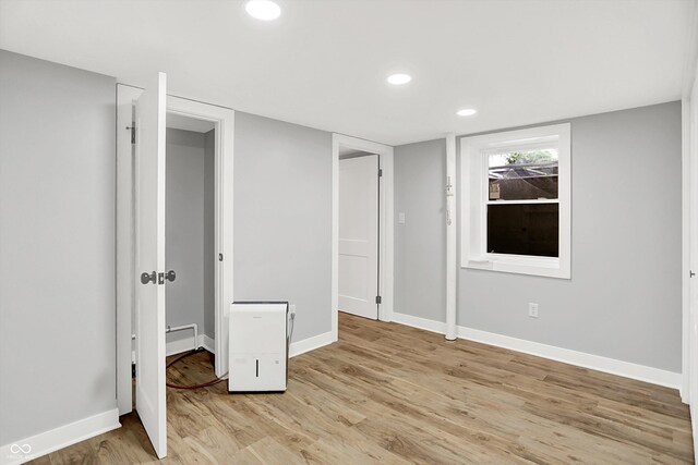6644 Mcfarland Rd, Indianapolis, IN 46227 - unfurnished bedroom with light wood-style flooring and recessed lighting