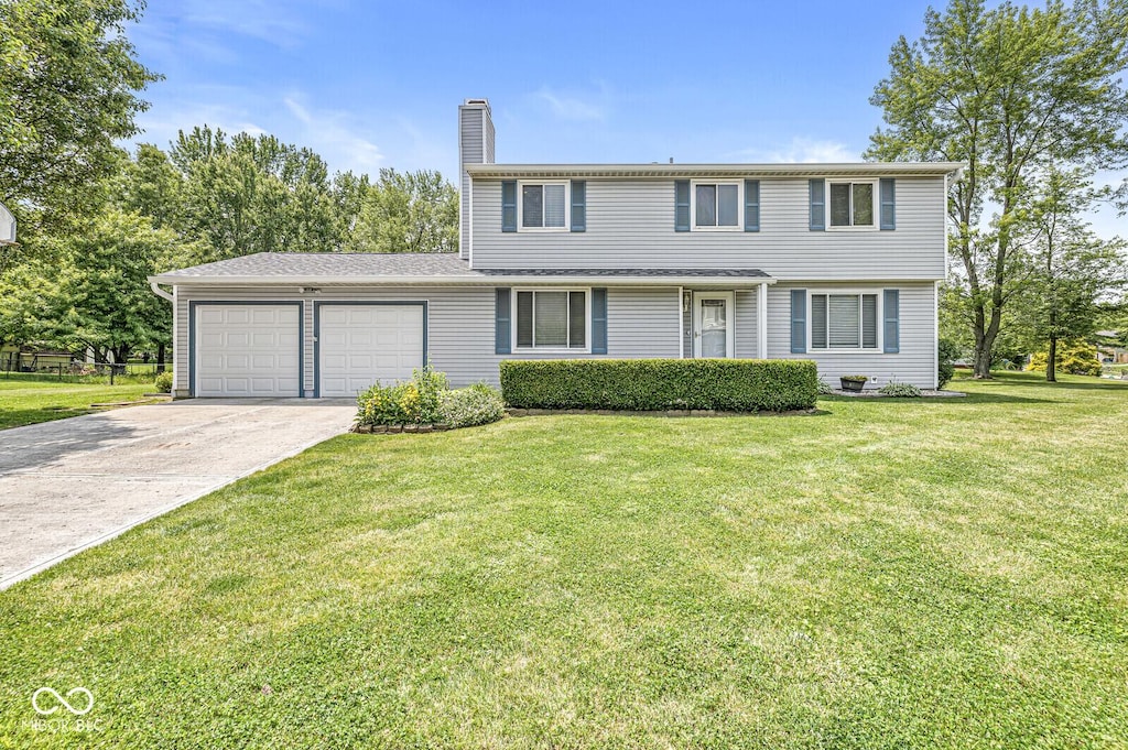 6601 Valley Forge Ct, Indianapolis, IN 46237 - colonial inspired home featuring an attached garage, a chimney, concrete driveway, and a front yard