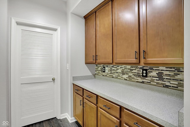 1343 Turfway Dr, Avon, IN 46123 - kitchen with decorative backsplash, light countertops, dark wood-style flooring, and brown cabinets
