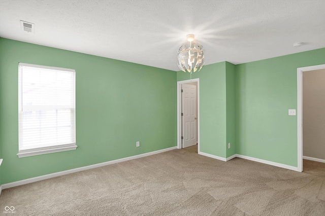 1343 Turfway Dr, Avon, IN 46123 - spare room featuring healthy amount of natural light, carpet floors, a chandelier, and a textured ceiling