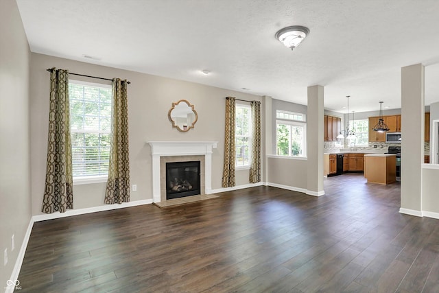 1343 Turfway Dr, Avon, IN 46123 - unfurnished living room featuring a tile fireplace and dark wood finished floors