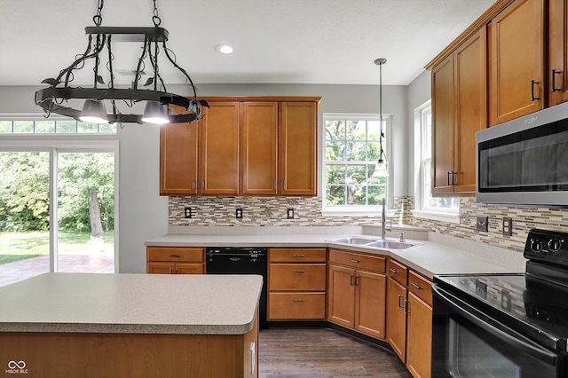1343 Turfway Dr, Avon, IN 46123 - kitchen with black appliances, backsplash, brown cabinets, light countertops, and recessed lighting