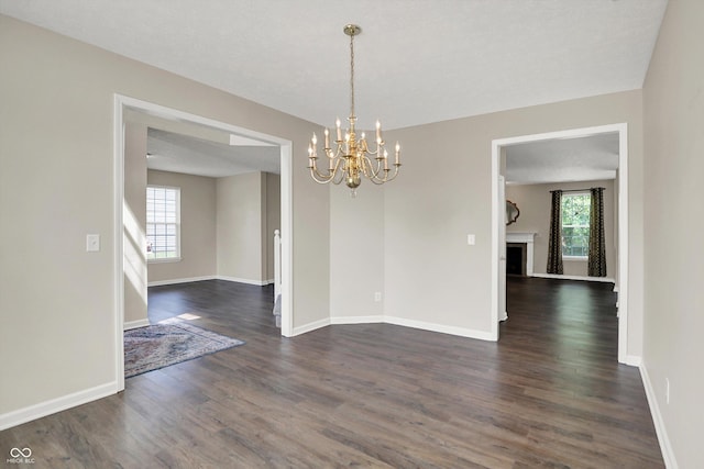 1343 Turfway Dr, Avon, IN 46123 - unfurnished room with dark wood-type flooring, a chandelier, and a fireplace
