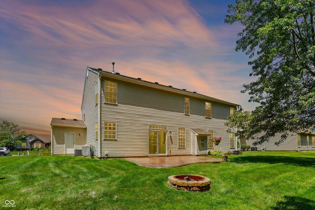 1343 Turfway Dr, Avon, IN 46123 - back of property at dusk with a fire pit, a patio, and a lawn