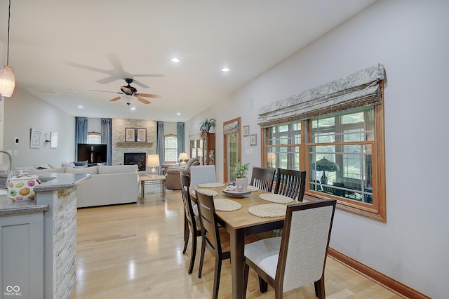 214 W Stoney Trl, Greenfield, IN 46140 - dining space featuring a fireplace, recessed lighting, light wood finished floors, and a ceiling fan