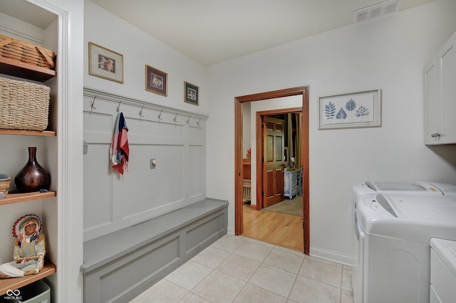 214 W Stoney Trl, Greenfield, IN 46140 - washroom with washer and clothes dryer, cabinet space, and light tile patterned floors