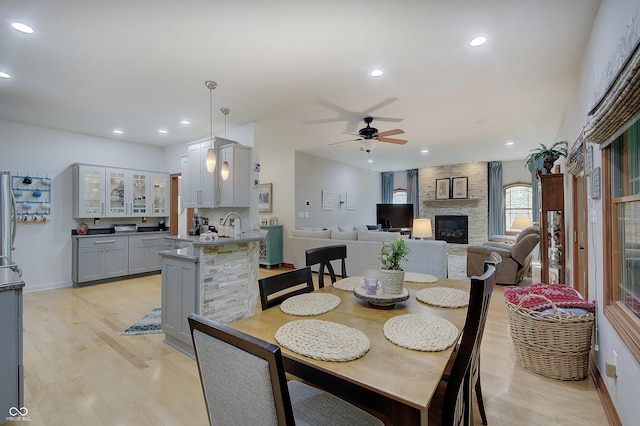214 W Stoney Trl, Greenfield, IN 46140 - dining space featuring recessed lighting, light wood-type flooring, a ceiling fan, and a stone fireplace