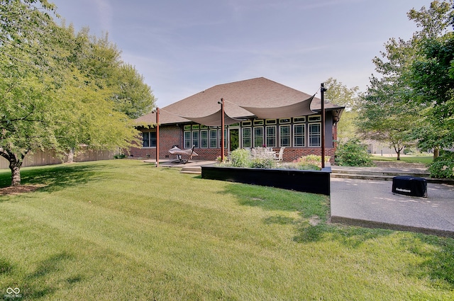 214 W Stoney Trl, Greenfield, IN 46140 - rear view of house with brick siding and a patio
