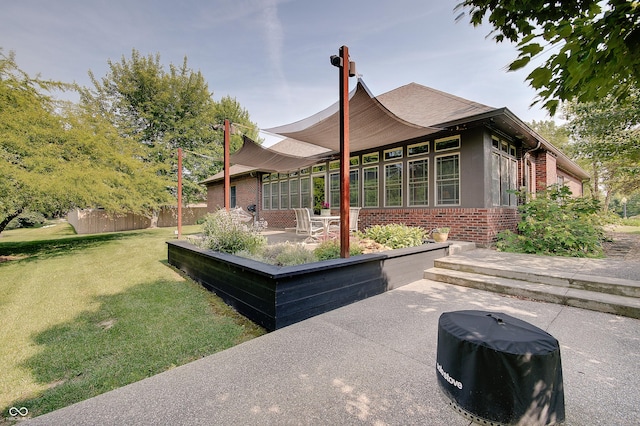 214 W Stoney Trl, Greenfield, IN 46140 - view of side of home with brick siding and a patio area