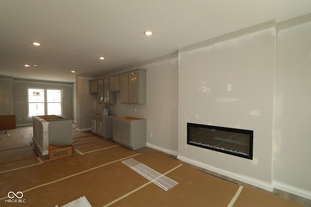 4151 Barrel Ln, Westfield, IN 46062 - kitchen with recessed lighting, a glass covered fireplace, baseboards, and gray cabinets