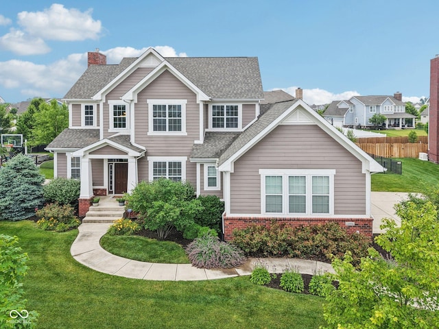 10806 Solis Cir, Fishers, IN 46038 - view of front facade featuring brick siding, a chimney, and roof with shingles