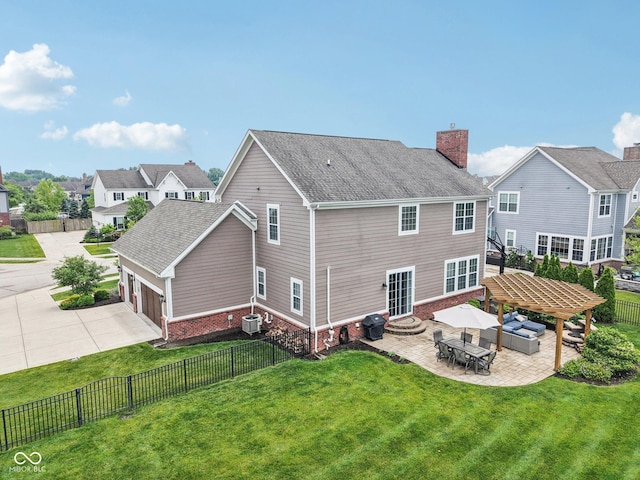 10806 Solis Cir, Fishers, IN 46038 - back of house with a fenced backyard, a chimney, brick siding, concrete driveway, and entry steps