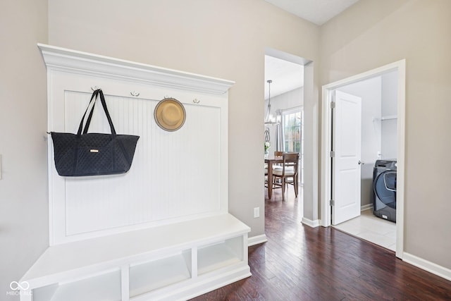 10806 Solis Cir, Fishers, IN 46038 - mudroom featuring washer / dryer, wood finished floors, and a chandelier