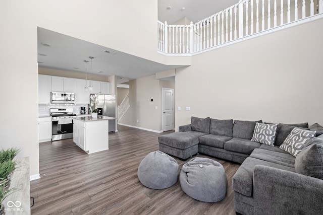 2892 Maricopa Blvd, Whitestown, IN 46075 - living room with stairway, dark wood-style floors, and a towering ceiling