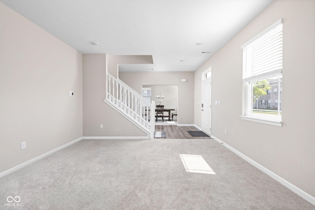 2892 Maricopa Blvd, Whitestown, IN 46075 - unfurnished living room featuring stairs and carpet floors