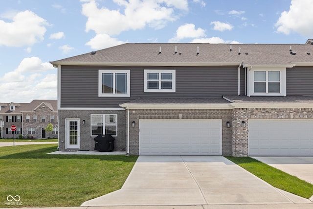 2892 Maricopa Blvd, Whitestown, IN 46075 - view of property featuring a front lawn, driveway, brick siding, and a garage