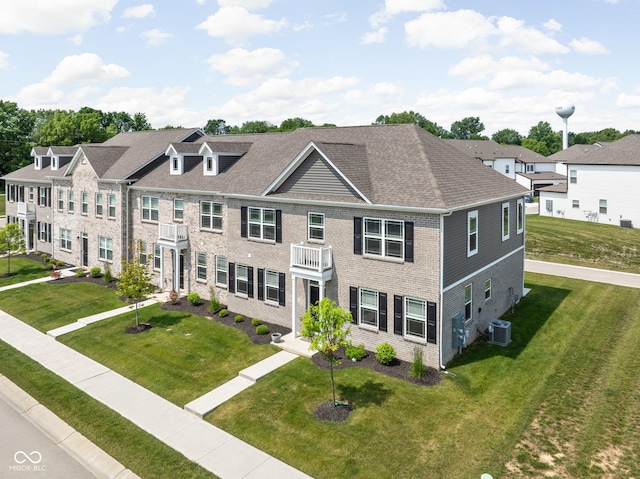 2892 Maricopa Blvd, Whitestown, IN 46075 - view of front of property with a front lawn, a residential view, brick siding, roof with shingles, and a balcony