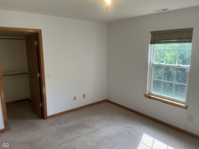 5632 Spring Mist Cir, Indianapolis, IN 46237 - unfurnished bedroom featuring carpet, a walk in closet, and baseboards