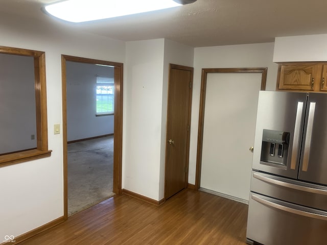 5632 Spring Mist Cir, Indianapolis, IN 46237 - kitchen featuring stainless steel refrigerator with ice dispenser, wood finished floors, and baseboards