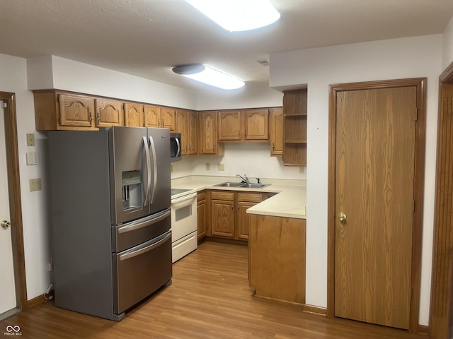 5632 Spring Mist Cir, Indianapolis, IN 46237 - kitchen with stainless steel appliances, a sink, light wood-style flooring, light countertops, and open shelves
