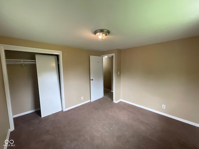 1749 N Graham Ave, Indianapolis, IN 46218 - unfurnished bedroom with dark colored carpet and a closet