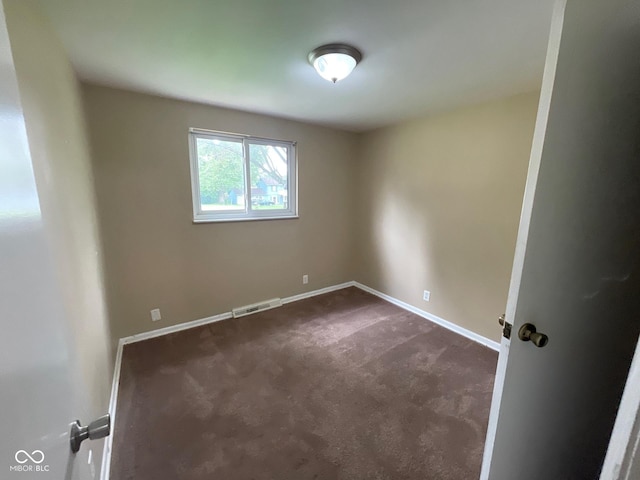 1749 N Graham Ave, Indianapolis, IN 46218 - unfurnished room featuring dark carpet and baseboards