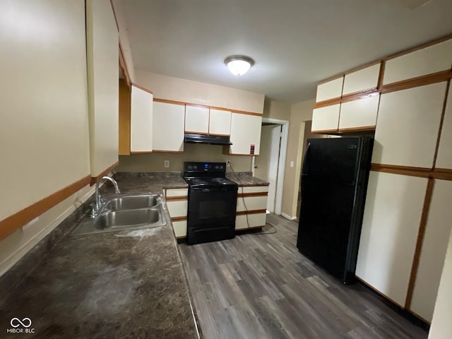 1749 N Graham Ave, Indianapolis, IN 46218 - kitchen with black appliances, under cabinet range hood, white cabinetry, and dark wood-style floors