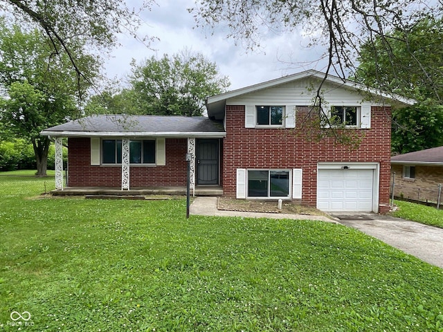 1749 N Graham Ave, Indianapolis, IN 46218 - split level home with driveway, a garage, brick siding, and a front yard