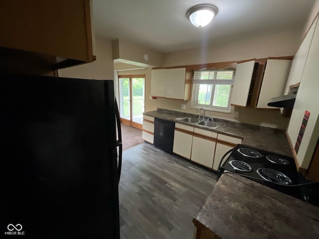 1749 N Graham Ave, Indianapolis, IN 46218 - kitchen with black appliances, white cabinetry, wood finished floors, and dark countertops