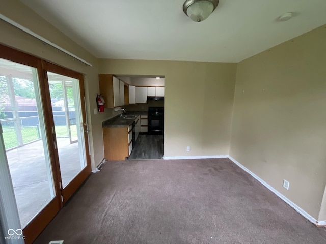 1749 N Graham Ave, Indianapolis, IN 46218 - unfurnished living room featuring a sink and dark colored carpet