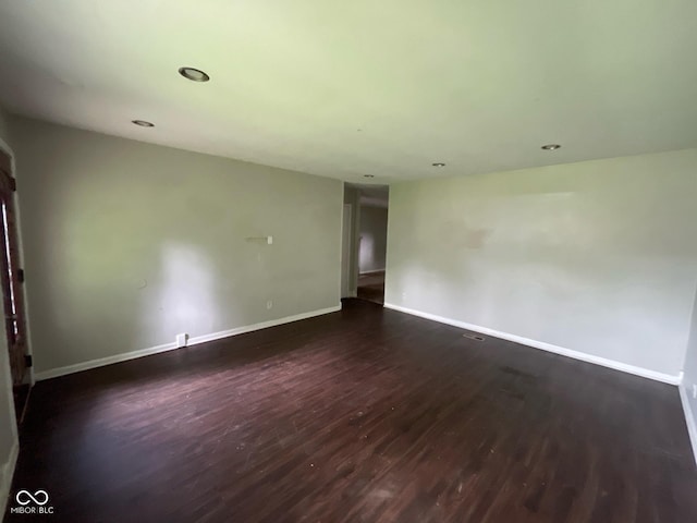 9045 Stardust Dr, Indianapolis, IN 46229 - empty room with dark wood finished floors and recessed lighting