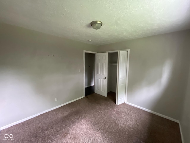 9045 Stardust Dr, Indianapolis, IN 46229 - unfurnished bedroom featuring carpet, a textured ceiling, and a closet