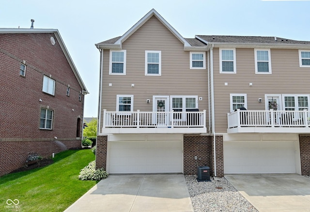 13616 Whitten Dr N, Fishers, IN 46037 - back of property featuring a garage, concrete driveway, brick siding, and a lawn