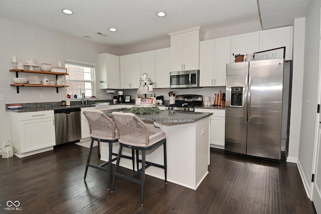 13616 Whitten Dr N, Fishers, IN 46037 - kitchen with appliances with stainless steel finishes, a kitchen island, recessed lighting, white cabinets, and dark wood finished floors