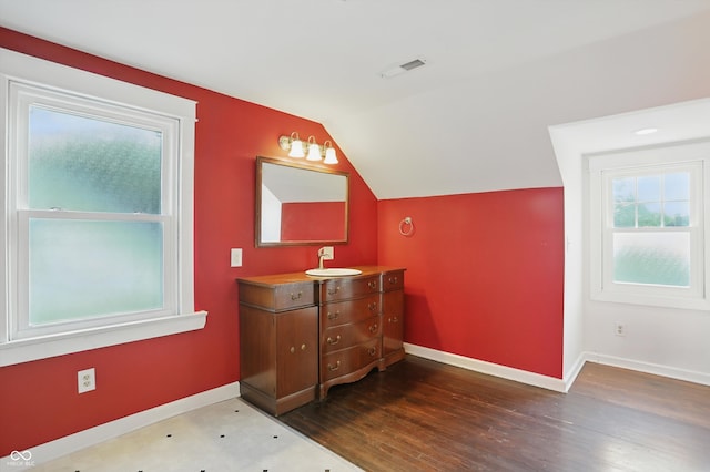 808 N Layman Ave, Indianapolis, IN 46219 - bathroom featuring vanity, vaulted ceiling, and wood finished floors