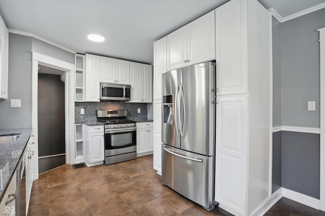 808 N Layman Ave, Indianapolis, IN 46219 - kitchen with appliances with stainless steel finishes, dark stone countertops, white cabinets, decorative backsplash, and crown molding