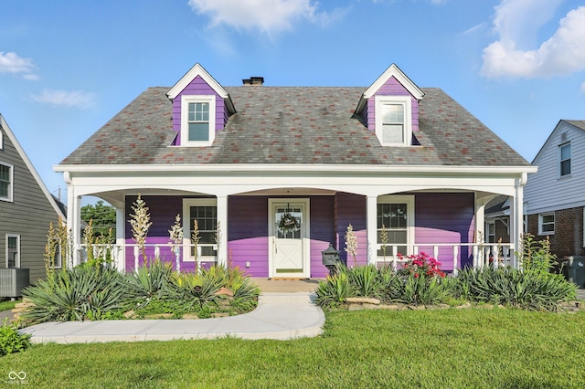 808 N Layman Ave, Indianapolis, IN 46219 - new england style home with a porch and a front yard