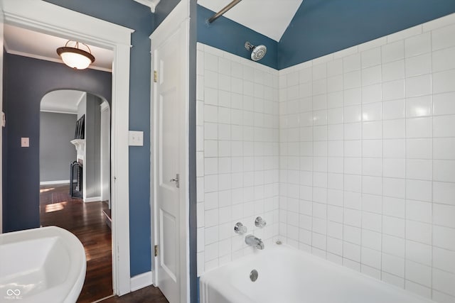 808 N Layman Ave, Indianapolis, IN 46219 - bathroom with shower / bathtub combination, wood finished floors, lofted ceiling, and a fireplace