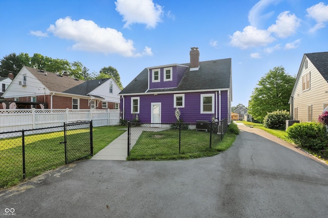 808 N Layman Ave, Indianapolis, IN 46219 - view of front of house featuring a chimney and a fenced front yard